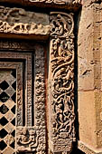 Orissa - Bhubaneshwar. Mukteswara temple, the large latticed window on the side of the jagmohana with all around figurines of lice-picking monkeys. 