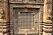 Orissa - Bhubaneshwar. Mukteswara temple, the large latticed window on the side of the jagmohana with all around figurines of lice-picking monkeys. 