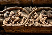 Orissa - Bhubaneshwar. Mukteswara temple, the large latticed window on the side of the jagmohana with all around figurines of lice-picking monkeys. 