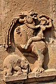 Orissa - Bhubaneshwar. Mukteswara temple, simha virala dragon with lion's head standing over a recumbent elephant with a knight raiding the monster. 