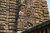 Orissa - Bhubaneswar. Parsurameswar Temple, the 'rahapaga', the western central projection of the deul, in the large 'chaitya' medallion the relief of Ravana shaking mount Kailash, above Shiva Nataraja. 