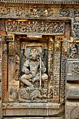 Orissa - Bhubaneswar. Parsurameswar Temple, central niche of the Eastern face of the deul, Kattrikeya, son of Shiva. The peacock, his mount, is killing a snake, the lintel of the niche is carved with an assembly of gods.  