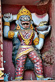 Orissa - Puri, colourful sculptures on the facade of a temple found along the road leading to the beach. 