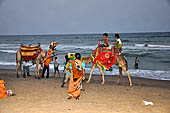 Orissa - Puri, the beach around sunset fills up with tourists and families. 