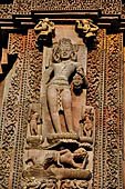 Orissa - Bhubaneswar. Rajarani temple, Nirriti (dikpala of south-west), god of suffering and misery on a prostrate figure and holding a severed head. 