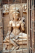 Ratnagiri - The main monastery. In the courtyard loose stone sculptures are still in situ. Images behind a protective grid.