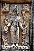 Ratnagiri - entrance porch of the main monastery - four armed Vajrapani flanked by a 'preta' and Hayagriva, his fierceful attendant. Above two Buddhas on lotus thrones. 