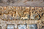 Udaigiri Cave 1 Rani Gumpha Queen's Cave - friezes of the upper storey. The Kalinga queen carried away by Ashoka. Fourth tableau: the hunt. By the sides of a tree the prince is shooting at a winged antelope. A naked woman looks down from a tree.