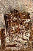 Khandagiri hill, Tatowa Gumpha n.2  the 'Parrot Cave', bracket with a female devotee holding a tray of flowers.