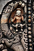 Udayagiri - Monastery n1. Decoration detail of the richly carved doorframe of the sanctum. Climbing acrobats. 