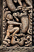 Udayagiri - Monastery n1. Decoration detail of the richly carved doorframe of the sanctum. Climbing acrobats. 