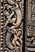 Udayagiri - Monastery n1. Decoration detail of the richly carved doorframe of the sanctum. Climbing acrobats. 