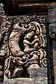 Udayagiri - Monastery n1. Decoration detail of the richly carved doorframe of the sanctum. Climbing acrobats. 