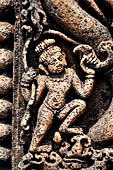 Udayagiri - Monastery n1. Decoration detail of the richly carved doorframe of the sanctum. Climbing acrobats. 