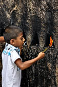 Aluvihara cave temples - Cavities in the rock boulders for oil lamps.