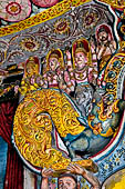 Aluvihara cave temples - Cave 1. Details of the dragon arch overhead of the Buddha with the face of the 'Kibihi' and Hindu gods.