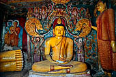 Aluvihara cave temples - Cave 1. The dragon arch overhead of the Buddha with the face of the 'Kibihi' and Hindu gods.