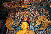 Aluvihara cave temples - Cave 1. The dragon arch overhead of the Buddha with the face of the 'Kibihi' and Hindu gods.