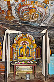 Dambulla cave temples - Cave 4, Paccima Viharaya (Western Temple). Buddha figure sits under an elaborate makara torana arch. 