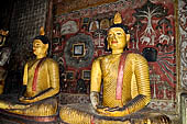 Dambulla cave temples - Cave 3, Maha Alut Viharaya (Great New Temple), behind a pair of seated Buddha's is a painting of a garden a nineteenth-century addition to the original Kandyan murals.