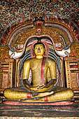 Dambulla cave temples - Cave 3, Maha Alut Viharaya (Great New Temple), The meditating  Buddha statue sits under a makara-torana where the typical makaras are replaced with white lions.