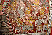 Dambulla  - Cave 2 Maharaja Vihara (Temple of the Great Kings) panels of the Defeat of Mara: Buddha is seated in bhumisparsha mudra (calling earth to witness) whilst demons attack him led by Mara  on elephant. 