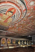 Dambulla cave temples - Cave 2, Maharaja Vihara (Temple of the Great Kings) panels of the Mara Parajaya (Defeat of Mara): the third panel shows the Isipatana: Buddha seated in the vitarka mudra gives the first sermon to an assembly of gods.