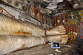 Dambulla cave temples - the narrow Cave 1, Devaraja Viharaya (Temple of the Lord of the Gods) is filled by a 14m-long sleeping Buddha, carved out of solid rock.