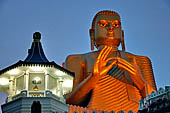 Dambulla cave. The Golden Temple at the site entrance. 30m-high Buddha image in the dhammachakra mudra (dhamma-turning pose).