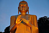 Dambulla cave. The Golden Temple at the site entrance. 30m-high Buddha image in the dhammachakra mudra (dhamma-turning pose).