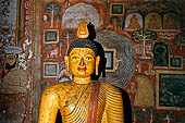 Dambulla cave temples - Cave 3, Maha Alut Viharaya (Great New Temple), behind a pair of seated Buddha's is a painting of a garden a nineteenth-century addition to the original Kandyan murals.