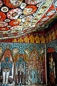 Mulkirigala cave temples - The first cave of the first terrace. Paintings of Vishnu, Kataragama, the demonic blue Vibhishana.