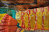 Mulkirigala cave temples - Third terrace. The Aluth Viharaya. Decorated feet of the reclined Buddha statue. 