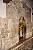 Kandy - The Sacred Tooth Relic Temple, carved stone entrance to the shrine,  adorned with a moonstone, guardstones and topped by a makara torana archway.