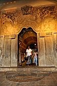 Kandy - The Sacred Tooth Relic Temple, carved stone entrance to the shrine,  adorned with a moonstone, guardstones and topped by a makara torana archway.