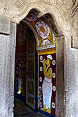 Kandy - The Sacred Tooth Relic Temple, carved stone entrance to the shrine,  adorned with a moonstone, guardstones and topped by a makara torana archway.