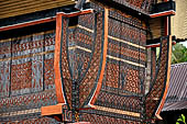 Bori Parinding villages - Traditional tongkonan house. The exterior walls are covered with wood panels etched with geometric patterns and painted with black and red colours. 