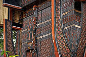 Bori Parinding villages - Traditional tongkonan house. The exterior walls are covered with wood panels etched with geometric patterns and painted with black and red colours. 