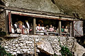 Londa - The entrance to the cave is guarded by a balcony of tau tau. 