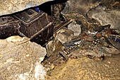 Londa - Inside the cave there is a collection of coffins, many of them rotted away, with the bones scattered or heaped in piles