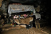 Londa - Inside the cave there is a collection of coffins, many of them rotted away, with the bones scattered or heaped in piles