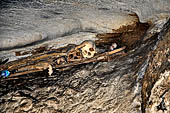 Londa - Inside the cave there is a collection of coffins, many of them rotted away, with the bones scattered or heaped in piles