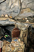 Londa - Inside the cave there is a collection of coffins, many of them rotted away, with the bones scattered or heaped in piles