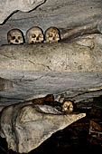 Londa - Inside the cave there is a collection of coffins, many of them rotted away, with the bones scattered or heaped in piles