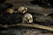 Londa - Inside the cave there is a collection of coffins, many of them rotted away, with the bones scattered or heaped in piles