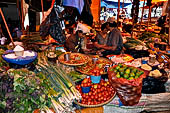 The market of Makale - stalls selling local produce including coffee, tobacco, buckets of live eels, piles of fresh and dried fish, and jugs of  'balok'