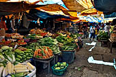 The market of Makale - stalls selling local produce including coffee, tobacco, buckets of live eels, piles of fresh and dried fish, and jugs of  'balok'