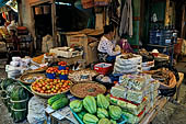 The market of Makale - stalls selling local produce including coffee, tobacco, buckets of live eels, piles of fresh and dried fish, and jugs of  'balok'