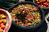 The market of Makale - stalls selling local produce including coffee, tobacco, buckets of live eels, piles of fresh and dried fish, and jugs of  'balok'