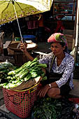 The market of Makale - stalls selling local produce including coffee, tobacco, buckets of live eels, piles of fresh and dried fish, and jugs of  'balok'